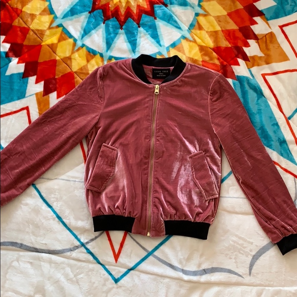 Pink velvet bomber jacket with gold zipper.